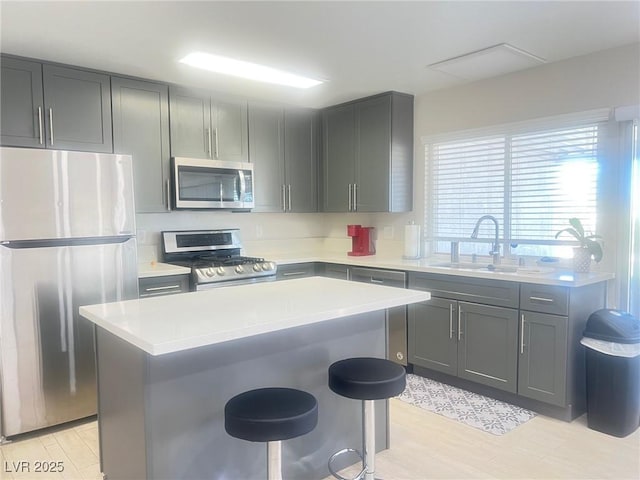 4194 Greenpoint St, Las Vegas, NV 89147 - kitchen with appliances with stainless steel finishes, light countertops, a kitchen breakfast bar, and light wood-style flooring