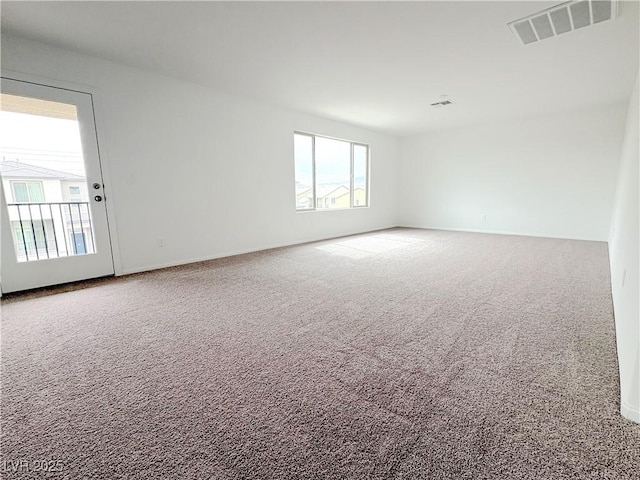 spare room featuring carpet floors and visible vents