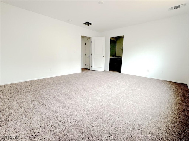 empty room featuring carpet and visible vents