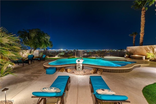 pool at night with a patio area, a fenced backyard, a fenced in pool, and an in ground hot tub