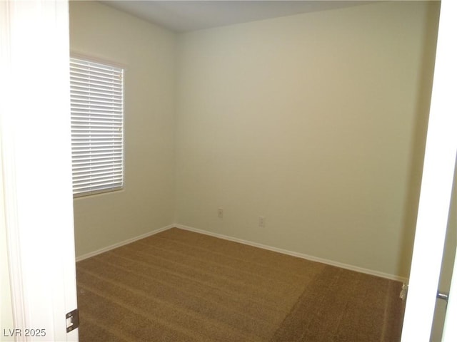 carpeted empty room with baseboards