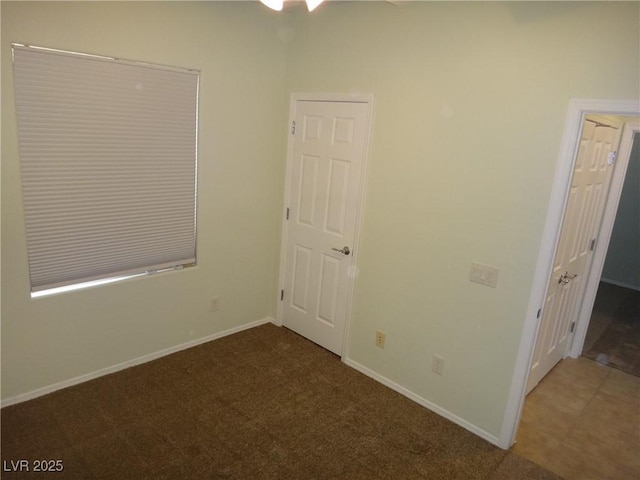 carpeted empty room with baseboards