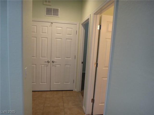 hallway with light tile patterned floors and visible vents