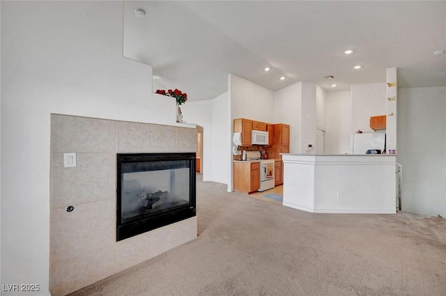 unfurnished living room featuring light carpet, a fireplace, and recessed lighting