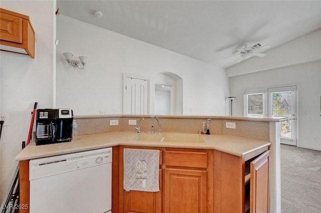 kitchen with white dishwasher, light carpet, a peninsula, a sink, and a ceiling fan