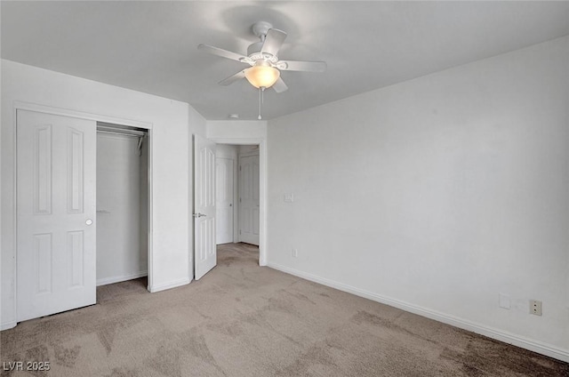 unfurnished bedroom featuring carpet floors, a closet, a ceiling fan, and baseboards