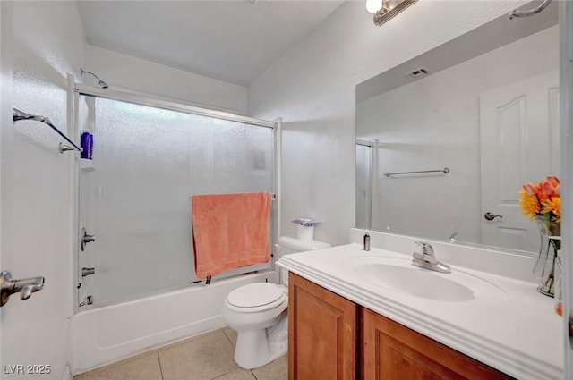 bathroom with visible vents, toilet, shower / bath combination with glass door, tile patterned floors, and vanity