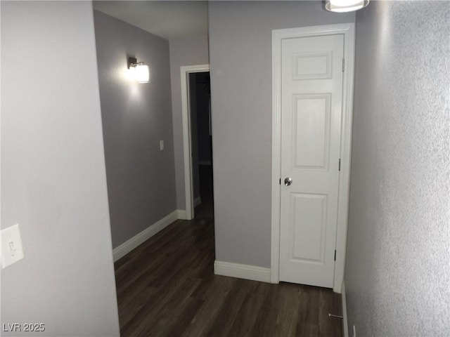 hallway with baseboards and dark wood finished floors