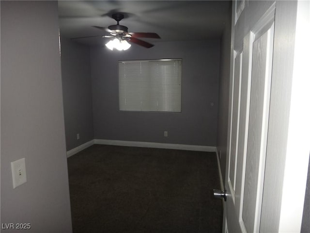 spare room with ceiling fan, carpet floors, and baseboards