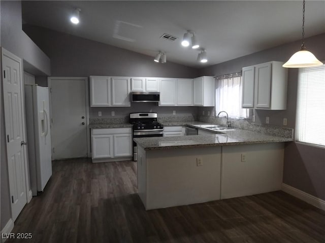 kitchen with extractor fan, a peninsula, white refrigerator with ice dispenser, a sink, and gas stove