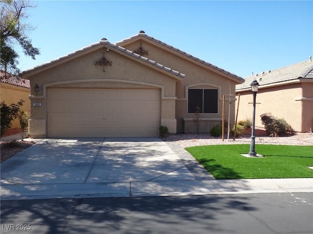 view of front of house with a garage, driveway, a tiled roof, stucco siding, and a front yard