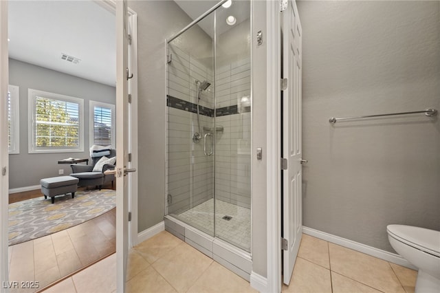 full bathroom featuring visible vents, a stall shower, tile patterned flooring, and toilet