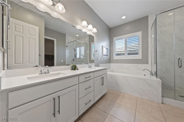 full bathroom featuring a bath, a stall shower, double vanity, and a sink