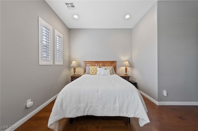 bedroom with recessed lighting, wood finished floors, visible vents, and baseboards