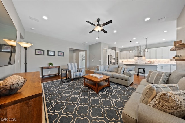 living room featuring a ceiling fan, wood finished floors, and recessed lighting