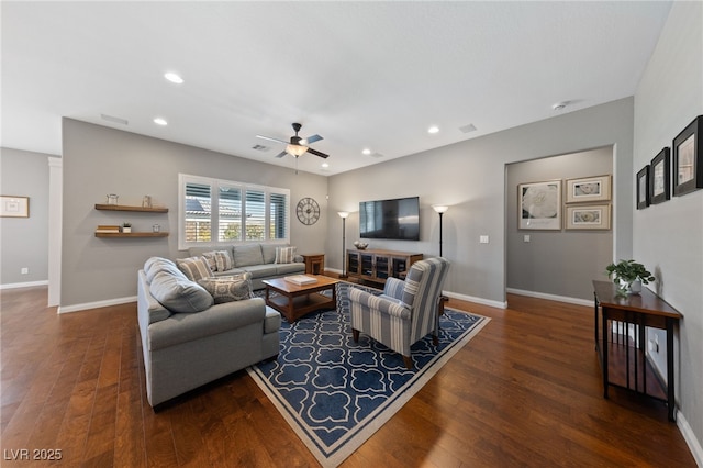 living room featuring baseboards, wood finished floors, and recessed lighting