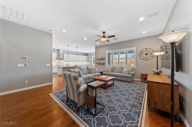 living area featuring recessed lighting, wood finished floors, visible vents, and baseboards