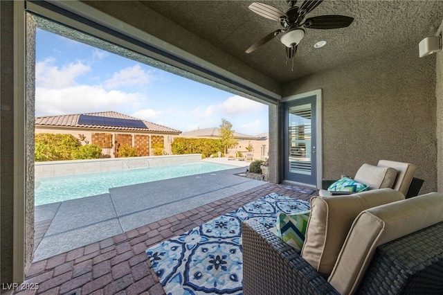 pool with ceiling fan and a patio