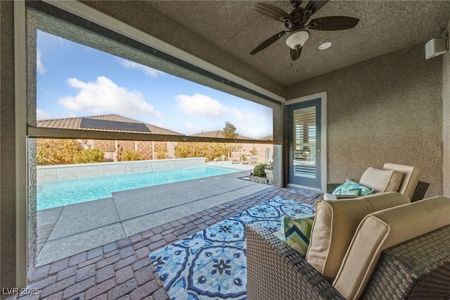 view of swimming pool with a fenced in pool, a patio area, and ceiling fan