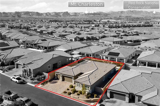 birds eye view of property with a mountain view and a residential view