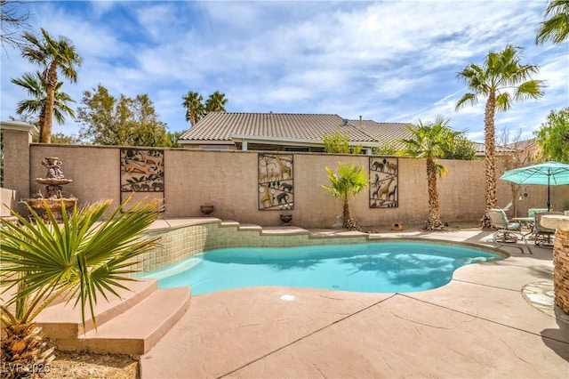 view of swimming pool featuring a patio, fence, and a fenced in pool