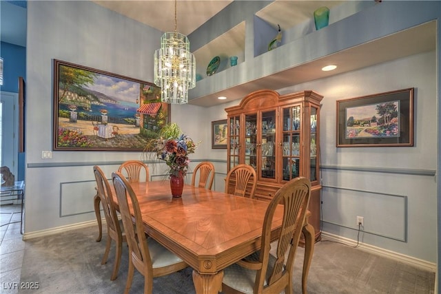 carpeted dining room with recessed lighting, baseboards, and an inviting chandelier