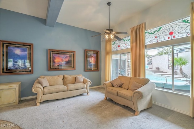 living area featuring light carpet, baseboards, and ceiling fan