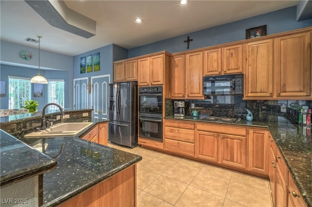 kitchen featuring visible vents, brown cabinetry, light tile patterned flooring, black appliances, and a sink