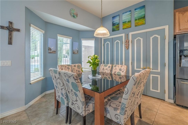 dining room featuring baseboards and light tile patterned flooring