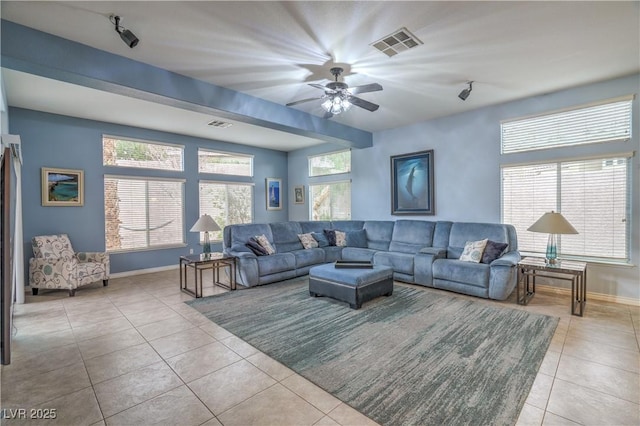 tiled living room with visible vents, plenty of natural light, baseboards, and ceiling fan