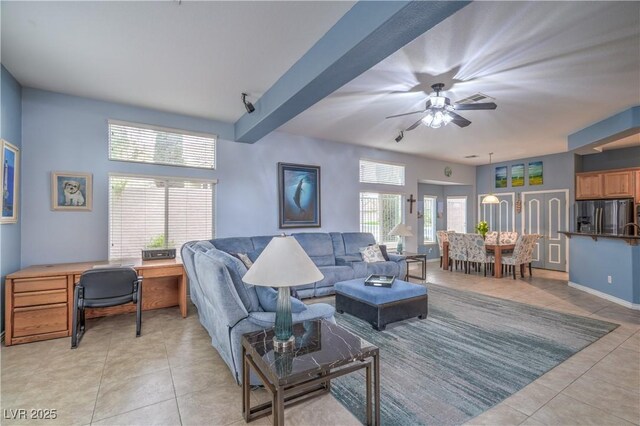 living room with light tile patterned floors, baseboards, and a ceiling fan