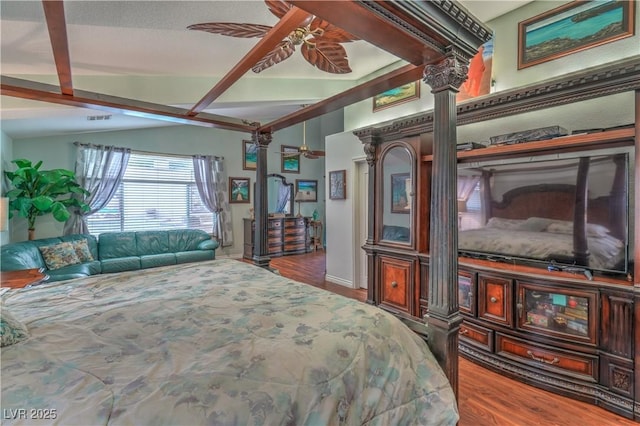 bedroom featuring decorative columns, wood finished floors, visible vents, and vaulted ceiling with beams