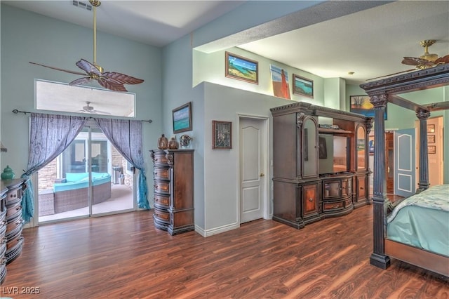 bedroom featuring access to outside, decorative columns, wood finished floors, and baseboards