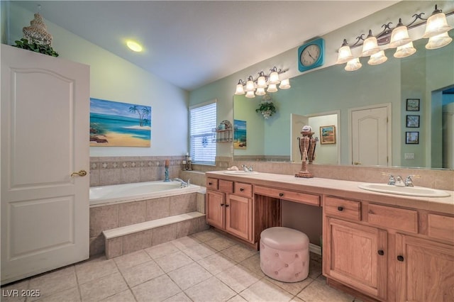 bathroom featuring lofted ceiling, a garden tub, double vanity, and a sink