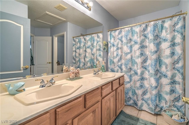 full bathroom featuring tile patterned floors, visible vents, double vanity, and a sink