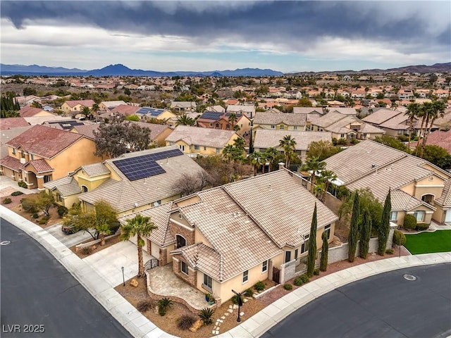 drone / aerial view featuring a residential view and a mountain view