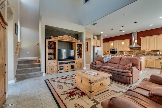 living room featuring stairs, visible vents, recessed lighting, and baseboards