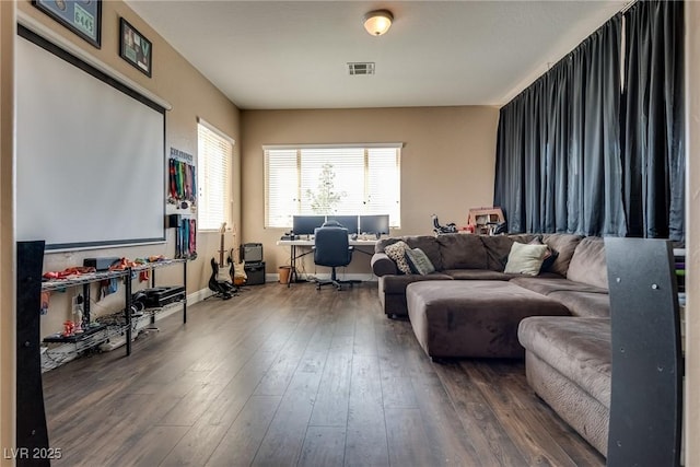 living area featuring hardwood / wood-style floors, baseboards, and visible vents