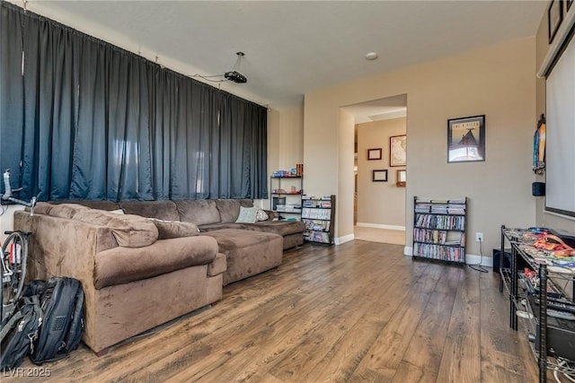 living area featuring baseboards and wood finished floors