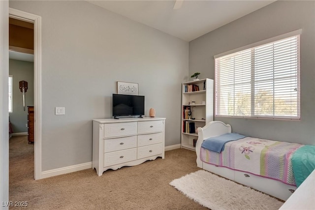 bedroom with baseboards, ceiling fan, and light colored carpet