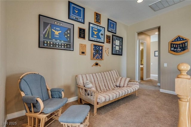 living area featuring carpet, baseboards, and visible vents