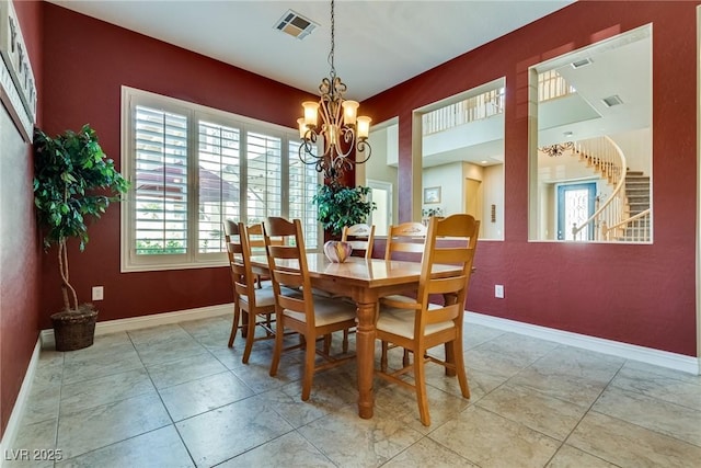 dining area with tile patterned floors, baseboards, a chandelier, and visible vents