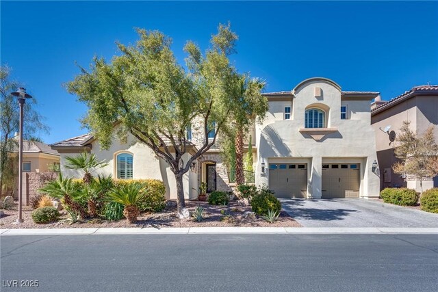 mediterranean / spanish-style home with stucco siding, driveway, and a garage