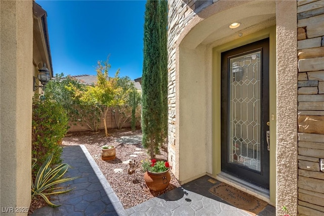 doorway to property featuring fence