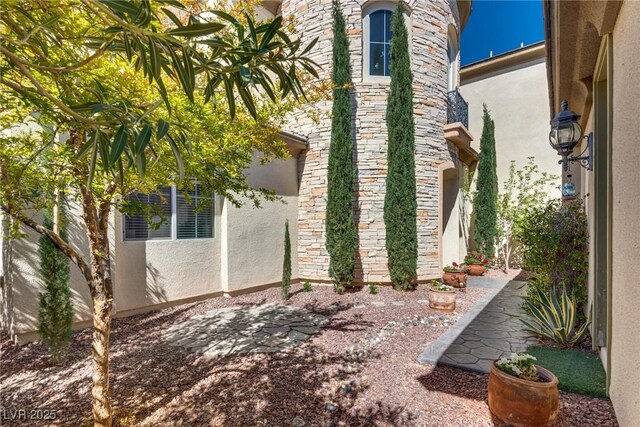 view of property exterior featuring stucco siding and stone siding