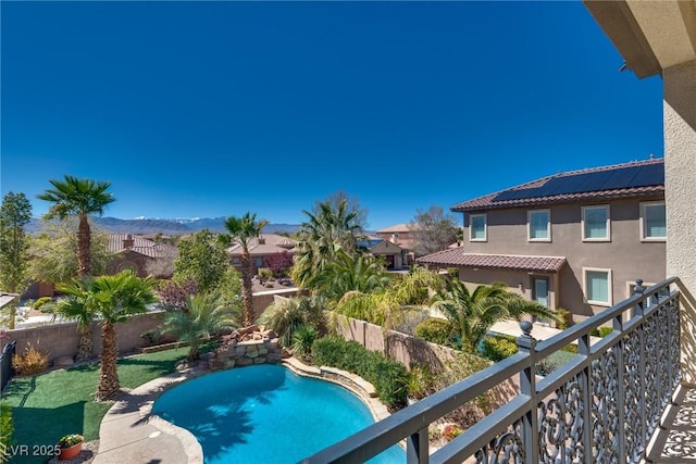 view of swimming pool featuring a fenced backyard, a mountain view, and a fenced in pool