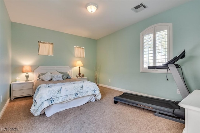 carpeted bedroom featuring baseboards and visible vents