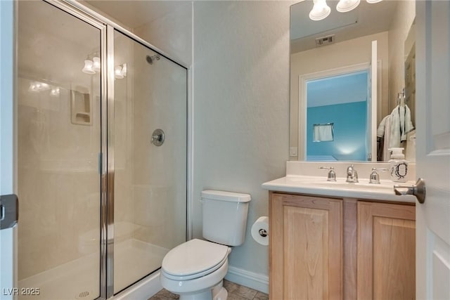 bathroom featuring visible vents, baseboards, toilet, vanity, and a stall shower