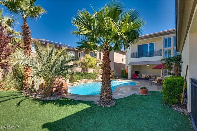view of swimming pool with a fenced in pool, a patio area, and a yard