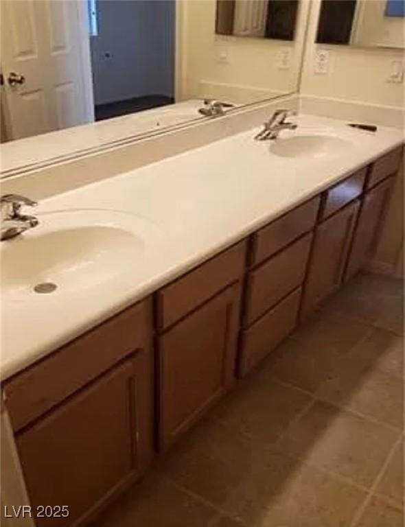 full bathroom featuring tile patterned flooring, a sink, and double vanity